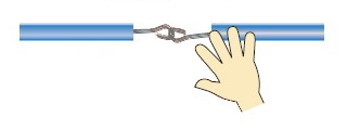 A hand dangerously touching an exposed high-voltage wire.